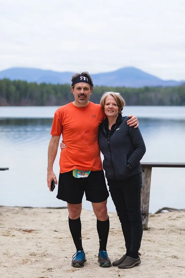 Two finishers on the beach by the lake