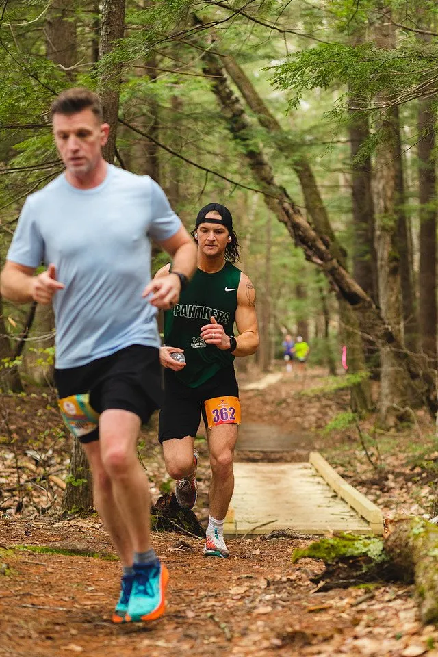Runners stepping off a footbridge