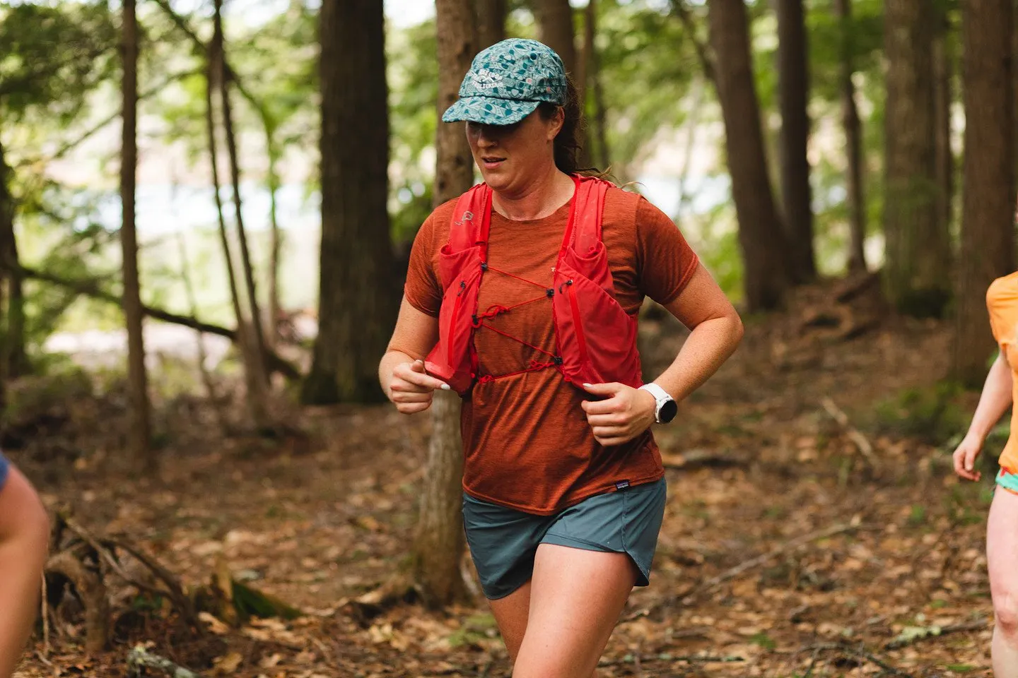 A runner in red on the forest trail