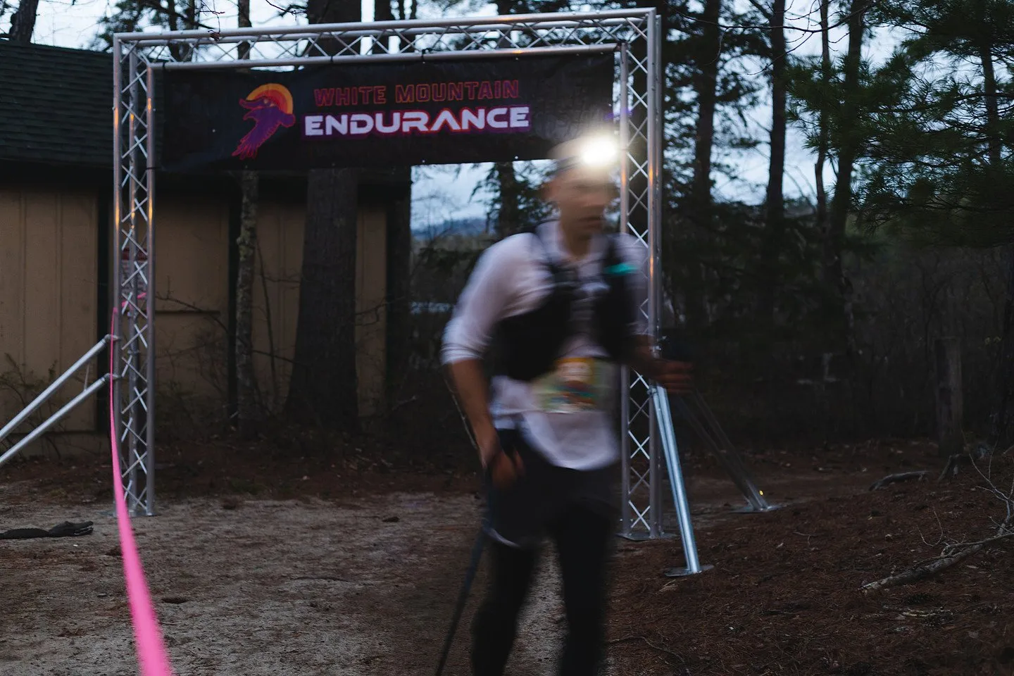 A finisher under the arch at night