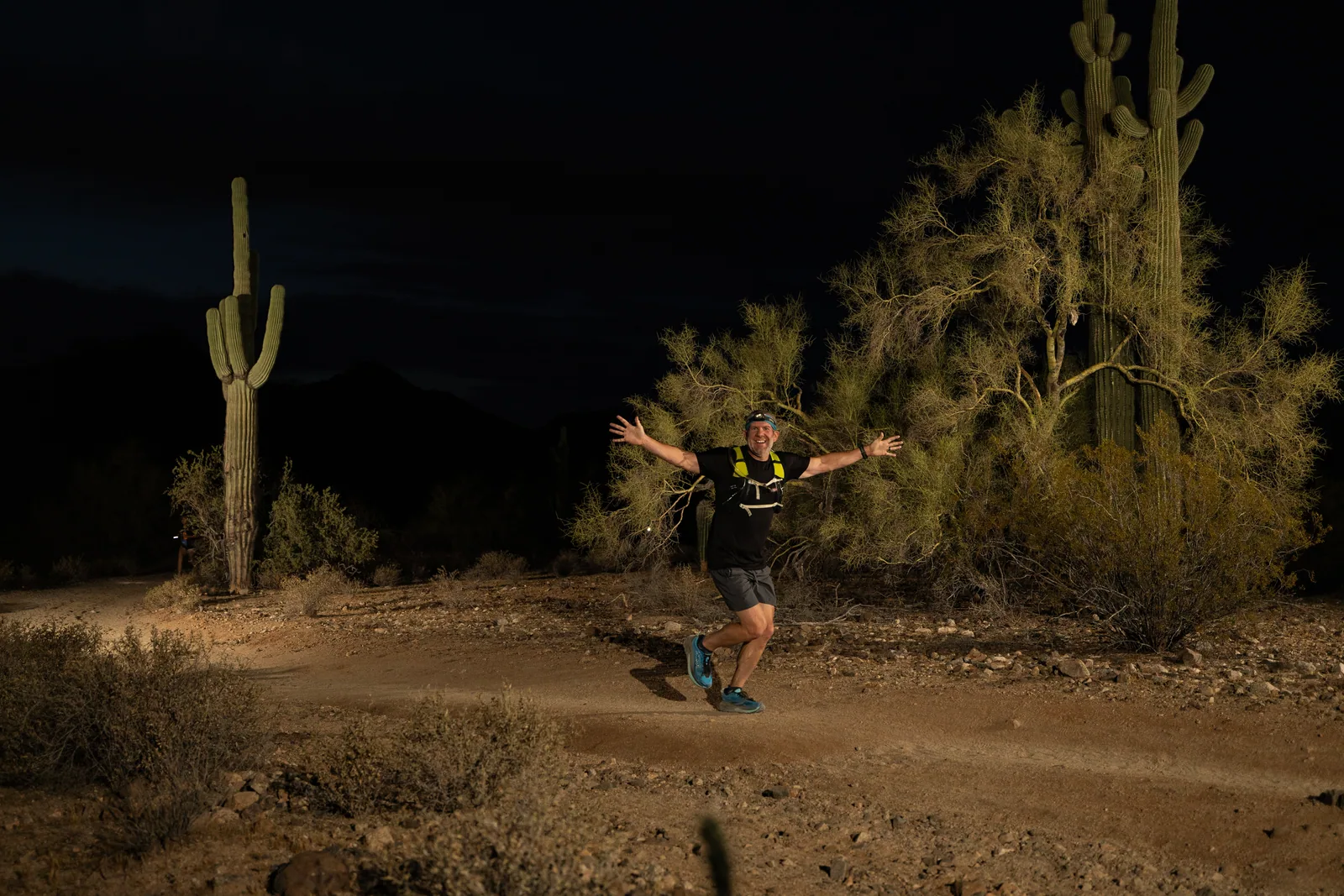 Runners among the saguaros at the Sinister Night Runs in San Tan Mountain Regional Park
