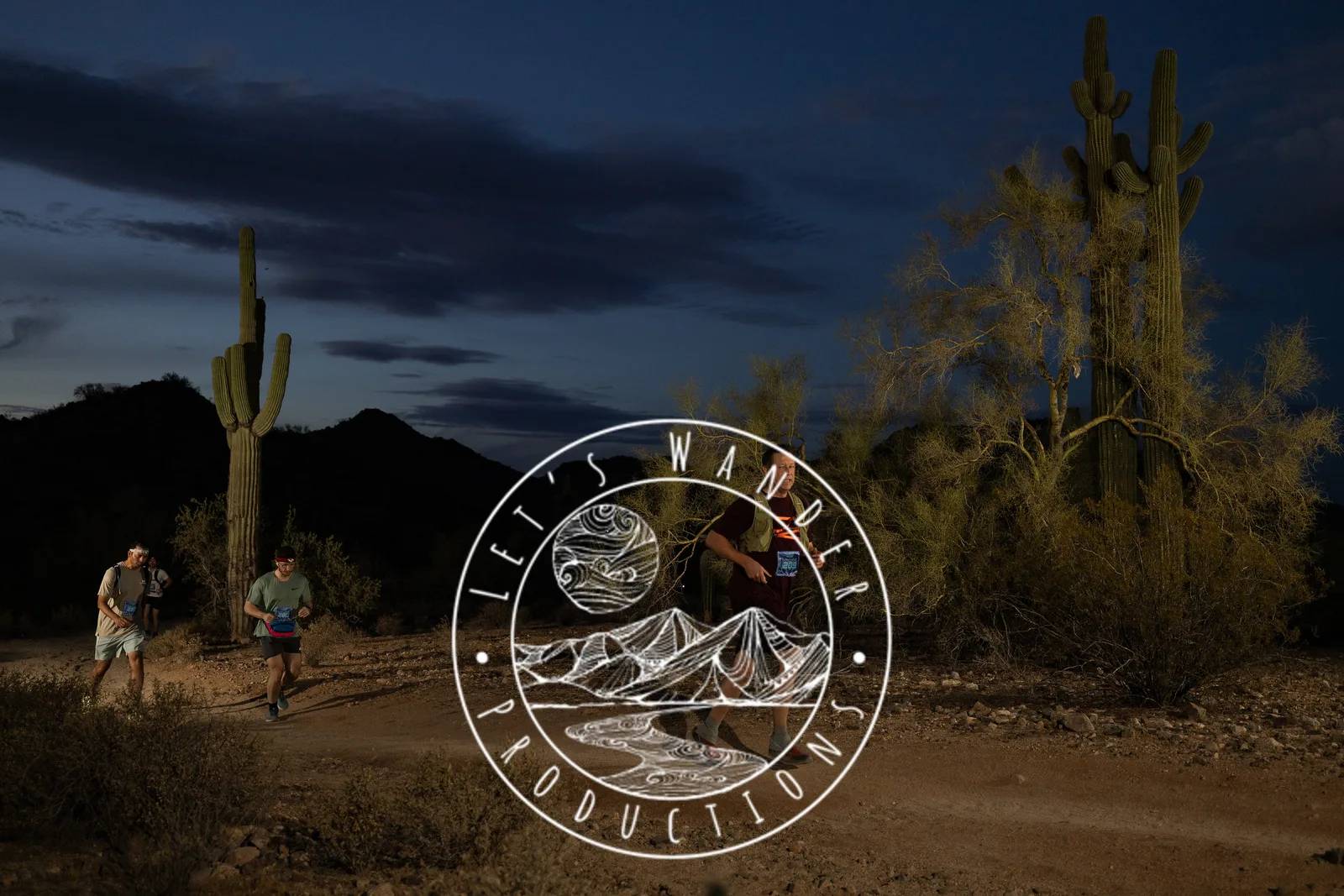 Runners among the saguaros at the Sinister Night Runs in San Tan Mountain Regional Park