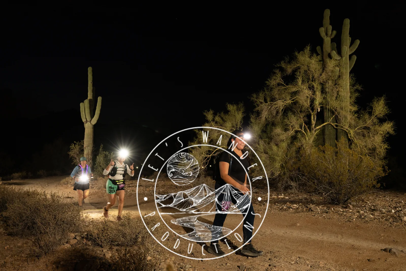 Runners among the saguaros at the Sinister Night Runs in San Tan Mountain Regional Park