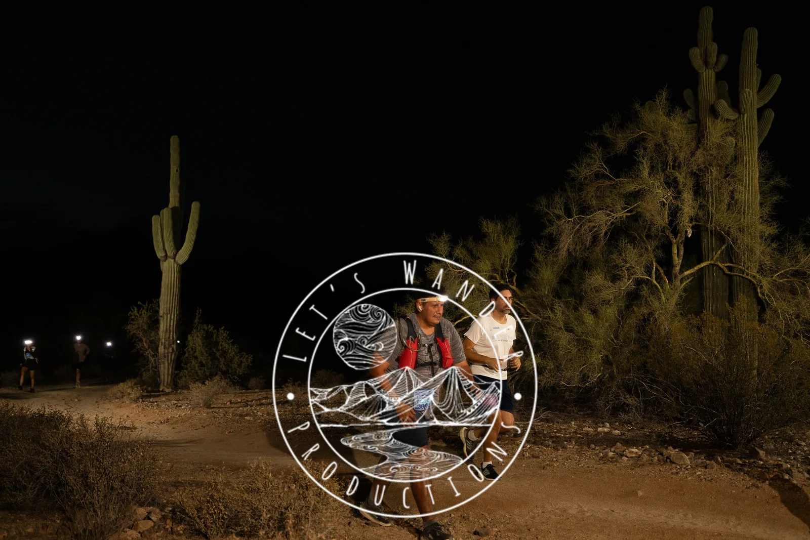 Runners among the saguaros at the Sinister Night Runs in San Tan Mountain Regional Park