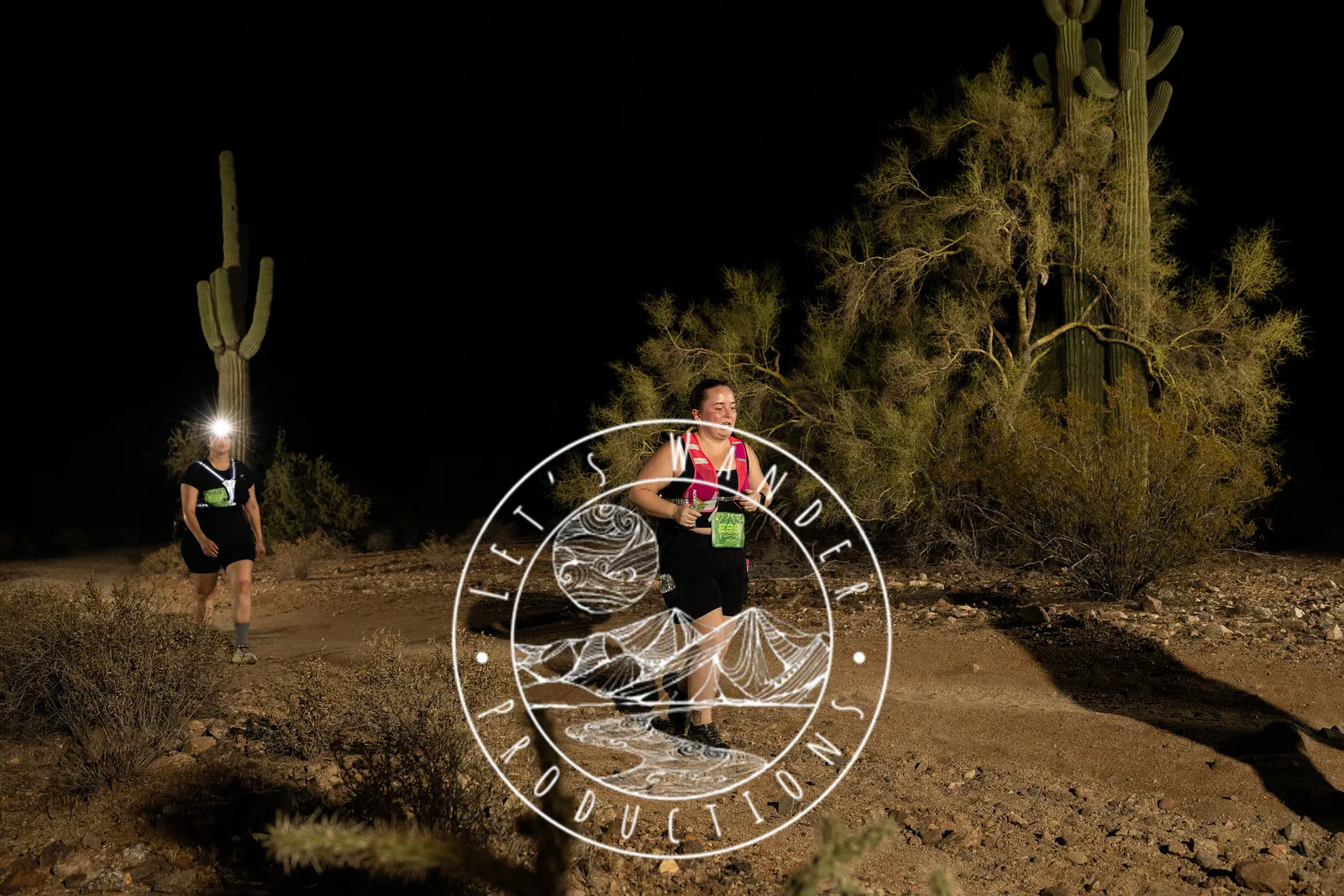 Runners among the saguaros at the Sinister Night Runs in San Tan Mountain Regional Park