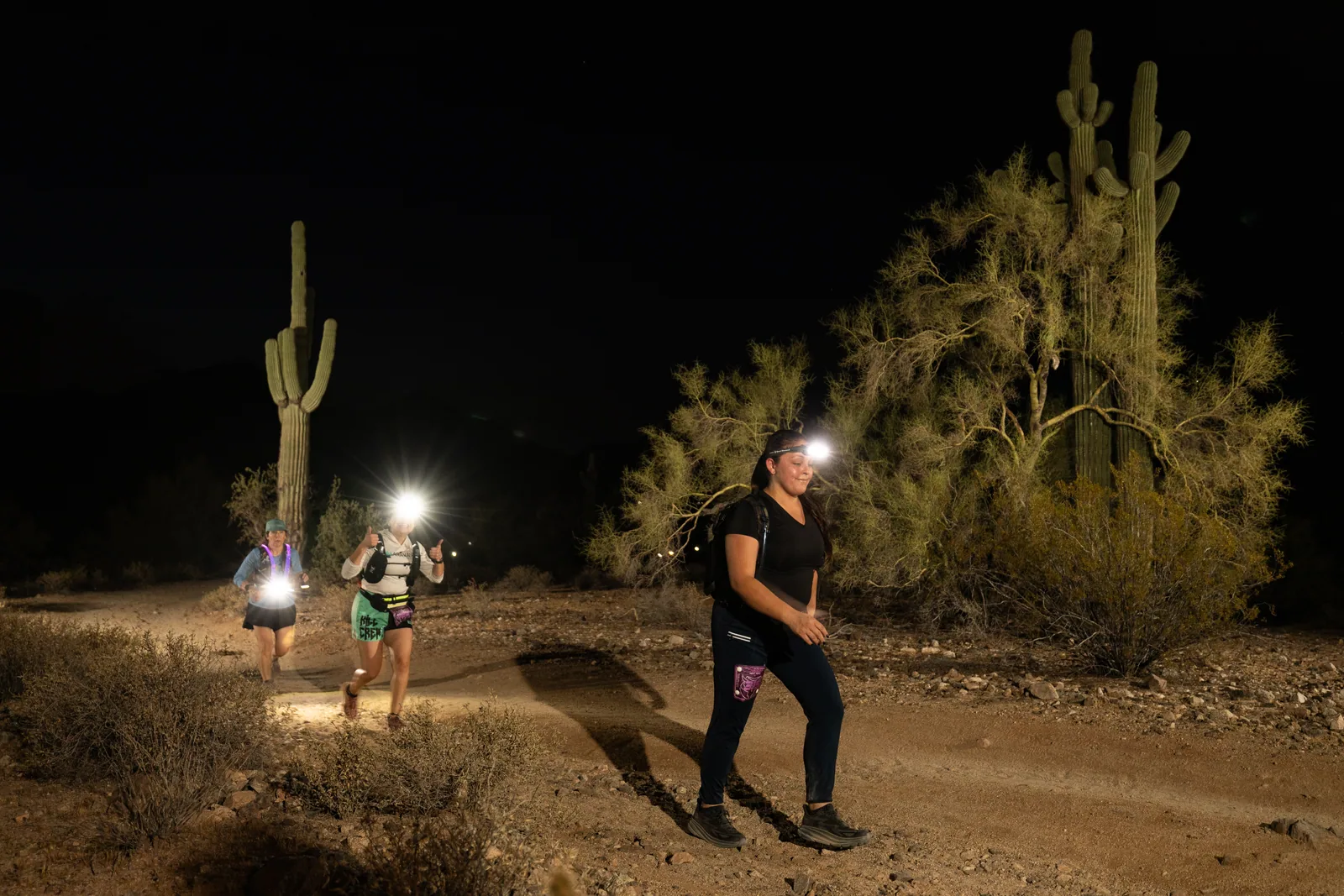 Runners among the saguaros at the Sinister Night Runs in San Tan Mountain Regional Park