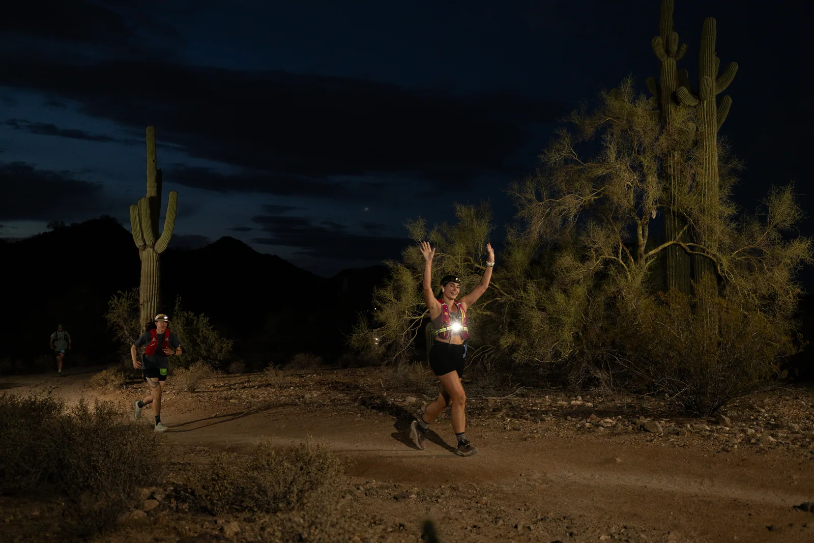 Runners among the saguaros at the Sinister Night Runs in San Tan Mountain Regional Park