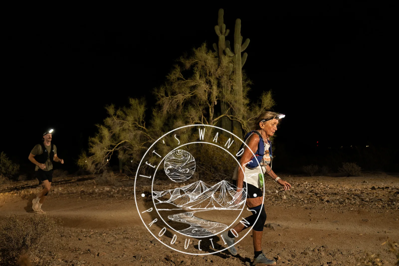 Runners among the saguaros at the Sinister Night Runs in San Tan Mountain Regional Park