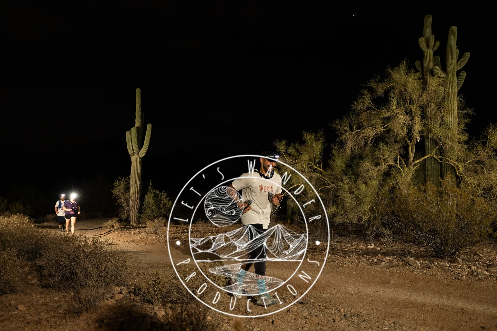 Runners among the saguaros at the Sinister Night Runs in San Tan Mountain Regional Park