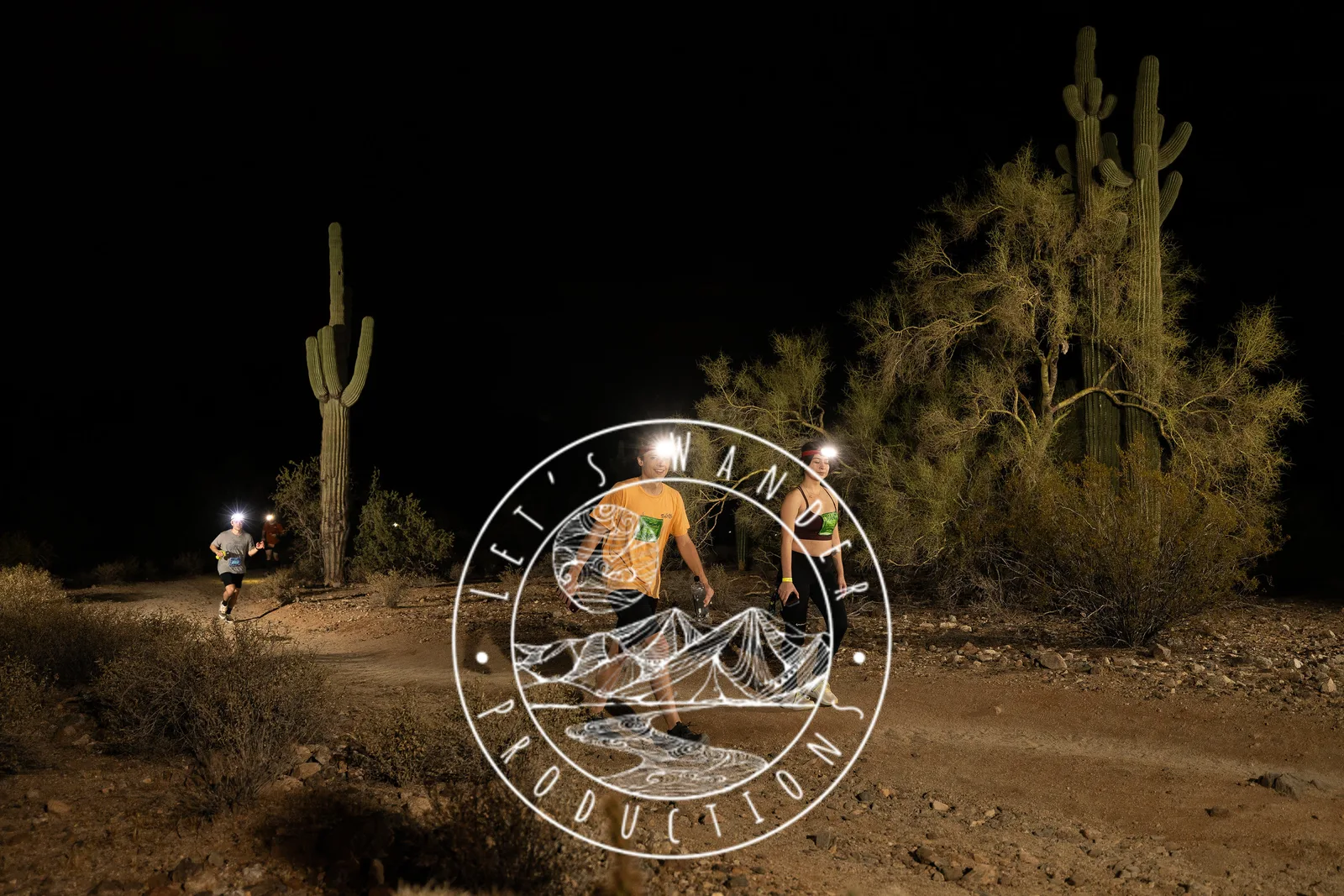 Runners among the saguaros at the Sinister Night Runs in San Tan Mountain Regional Park