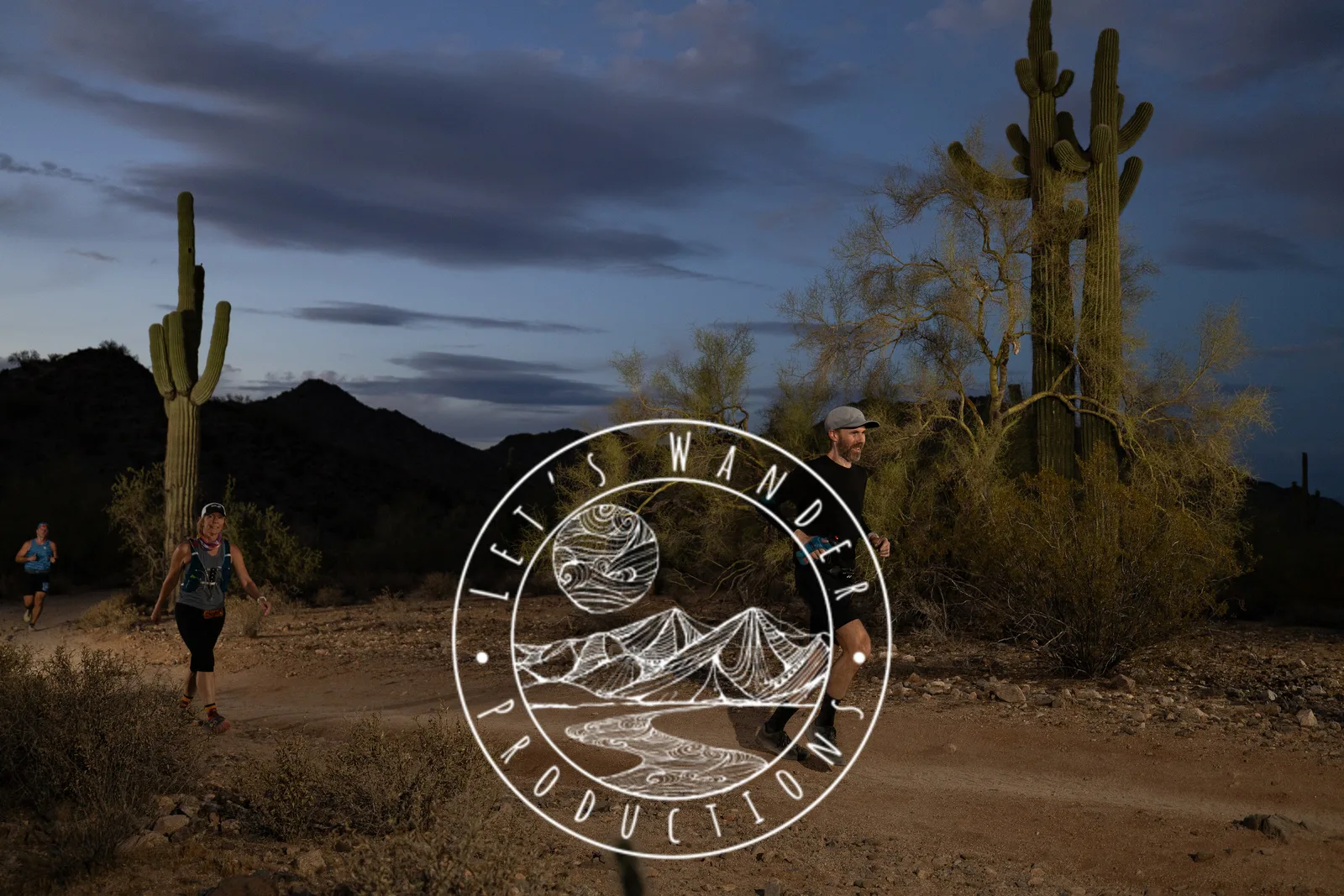 Runners among the saguaros at the Sinister Night Runs in San Tan Mountain Regional Park