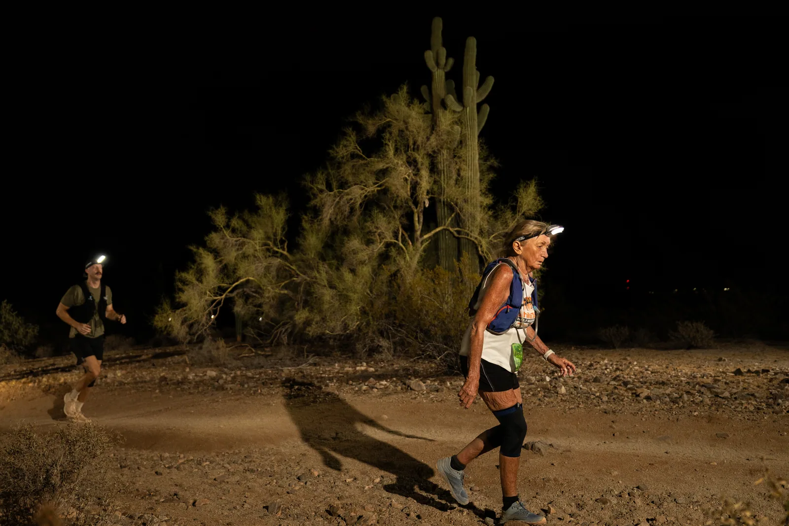 Runners among the saguaros at the Sinister Night Runs in San Tan Mountain Regional Park