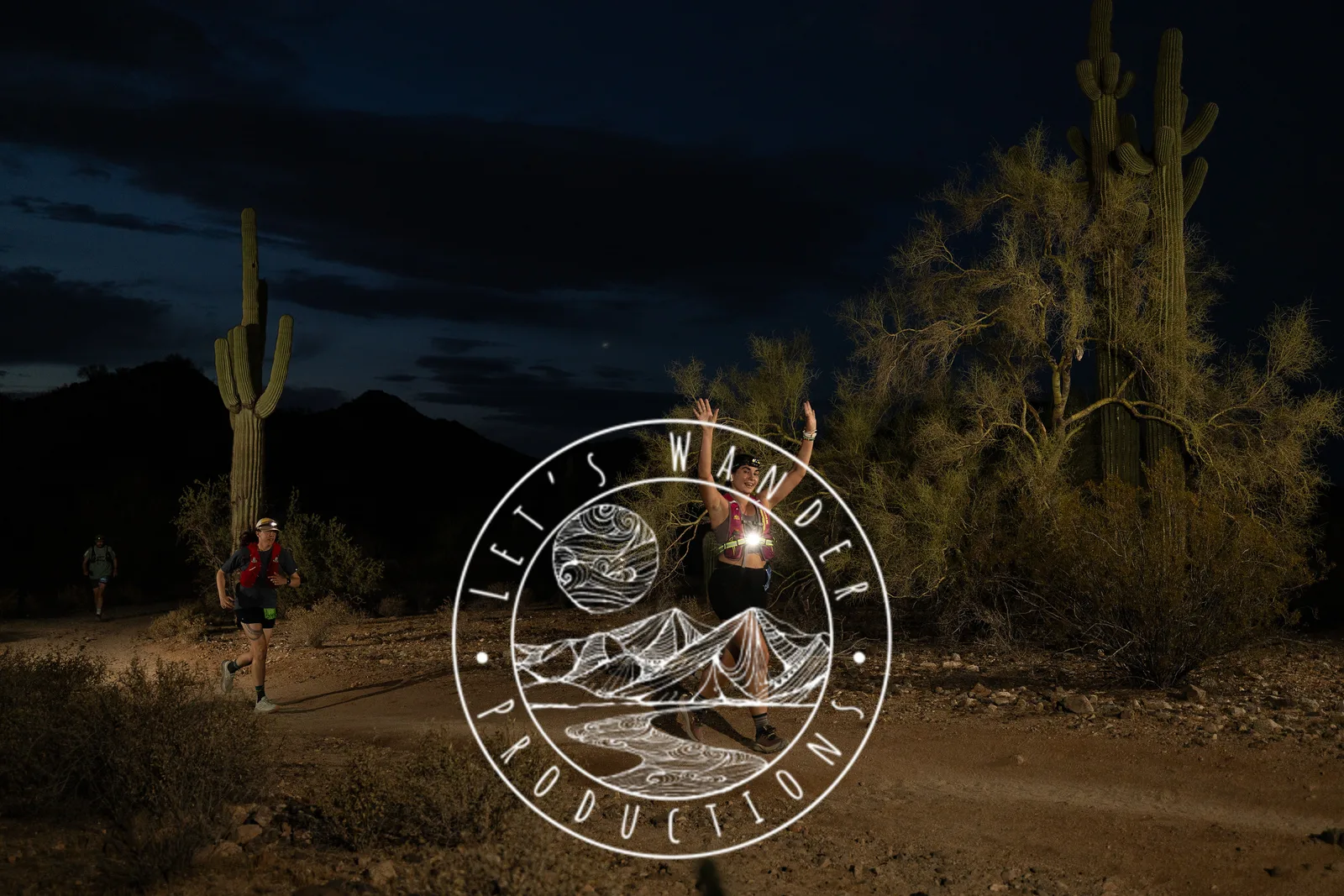 Runners among the saguaros at the Sinister Night Runs in San Tan Mountain Regional Park