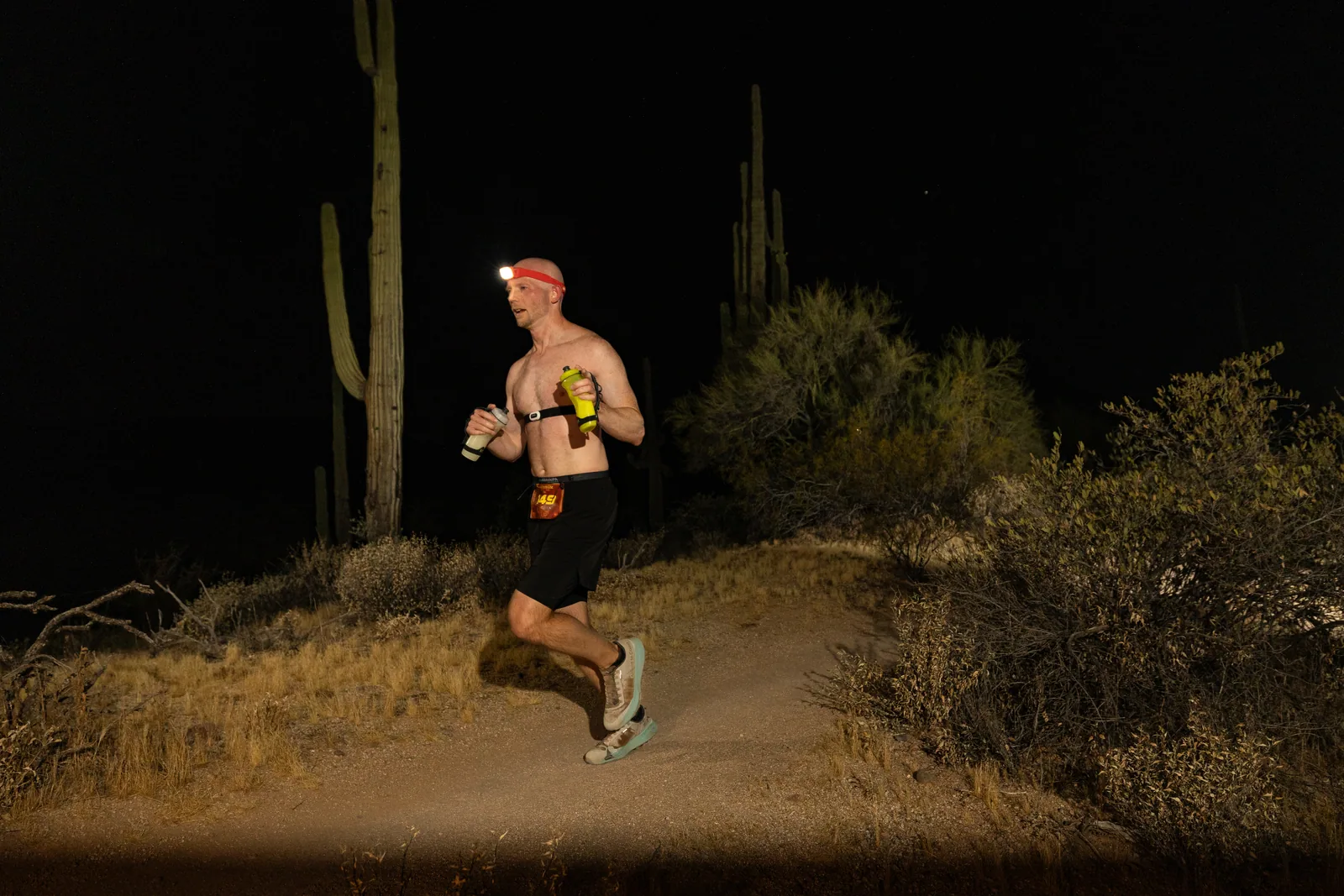 Runners by headlamp at the Adrenaline Night Runs in McDowell Mountain Regional Park