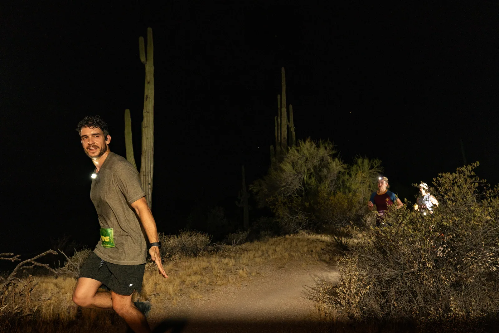Runners by headlamp at the Adrenaline Night Runs in McDowell Mountain Regional Park