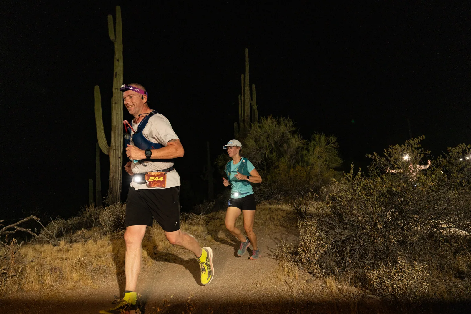 Runners by headlamp at the Adrenaline Night Runs in McDowell Mountain Regional Park