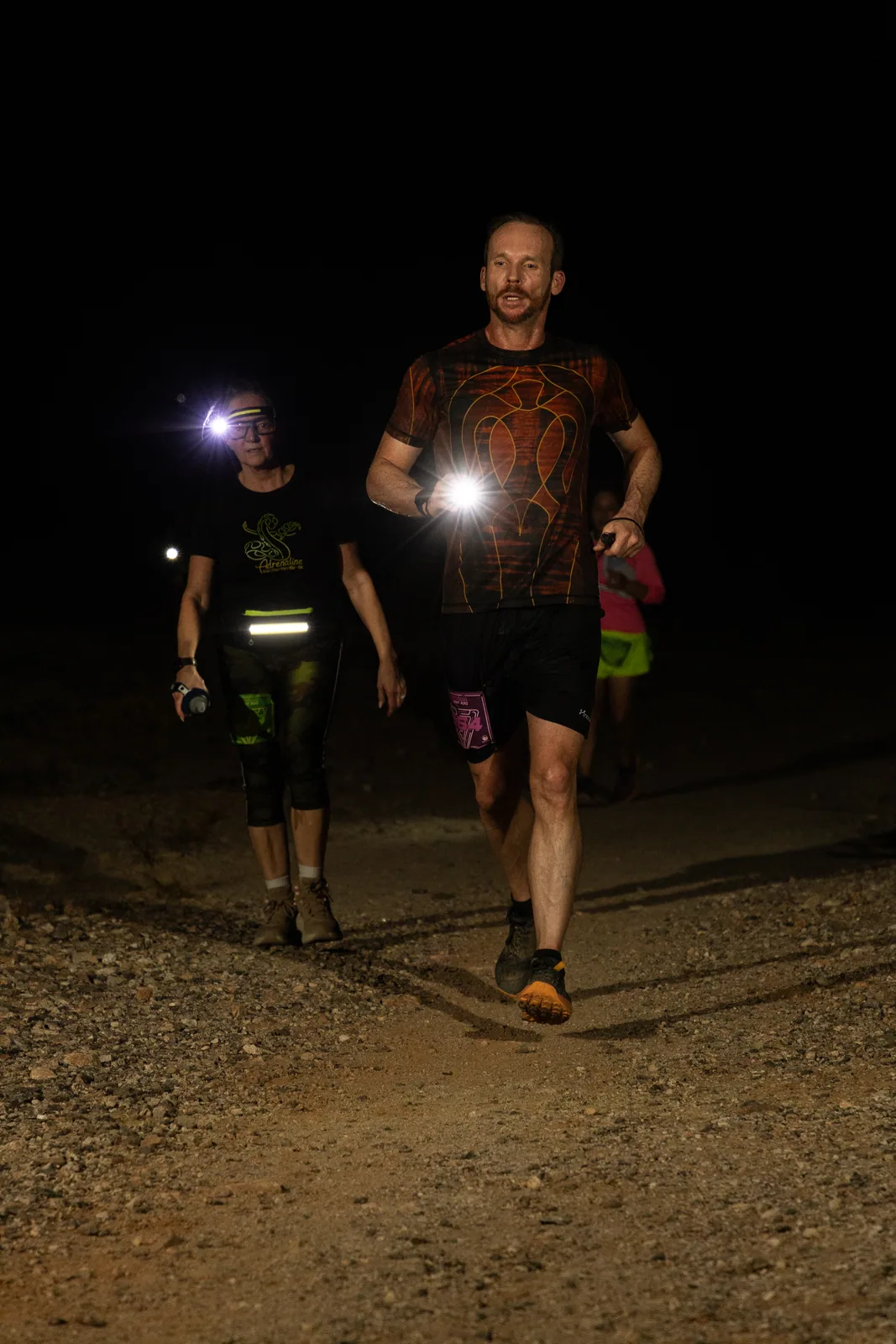 Runners by headlamp at the Hypnosis Night Runs at Estrella Mountain