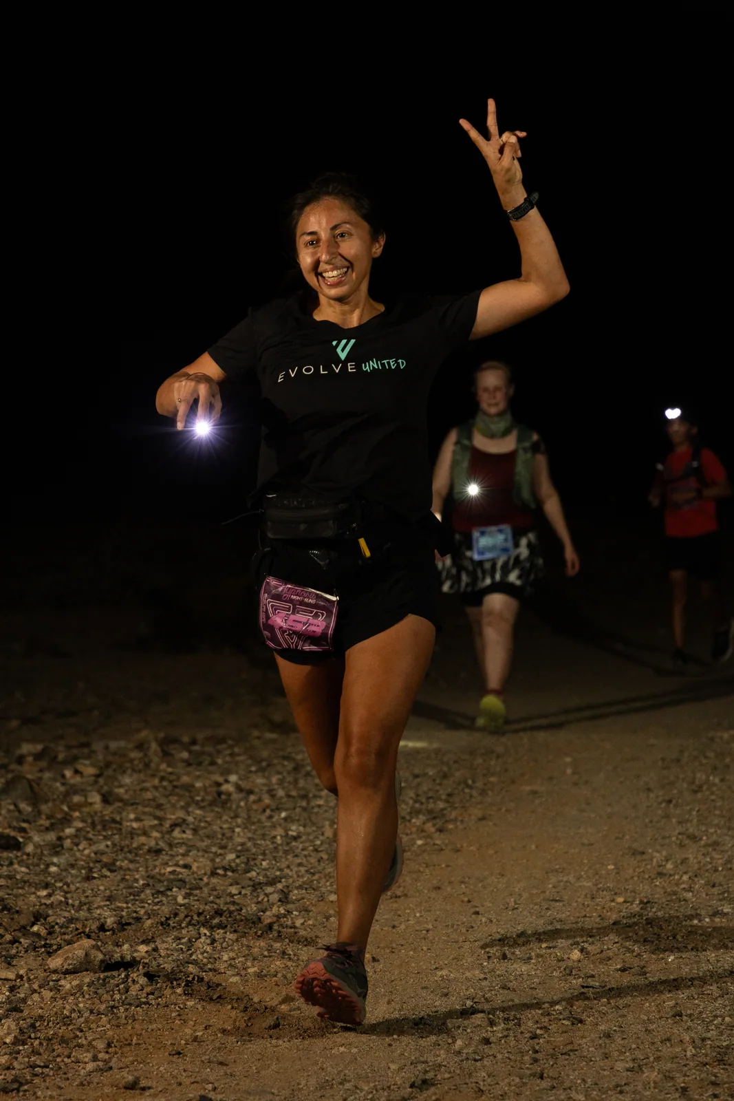 Runners by headlamp at the Hypnosis Night Runs at Estrella Mountain
