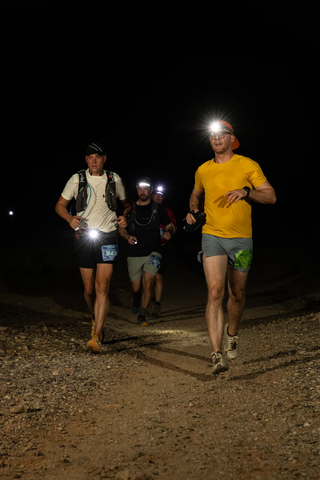 Runners by headlamp at the Hypnosis Night Runs at Estrella Mountain