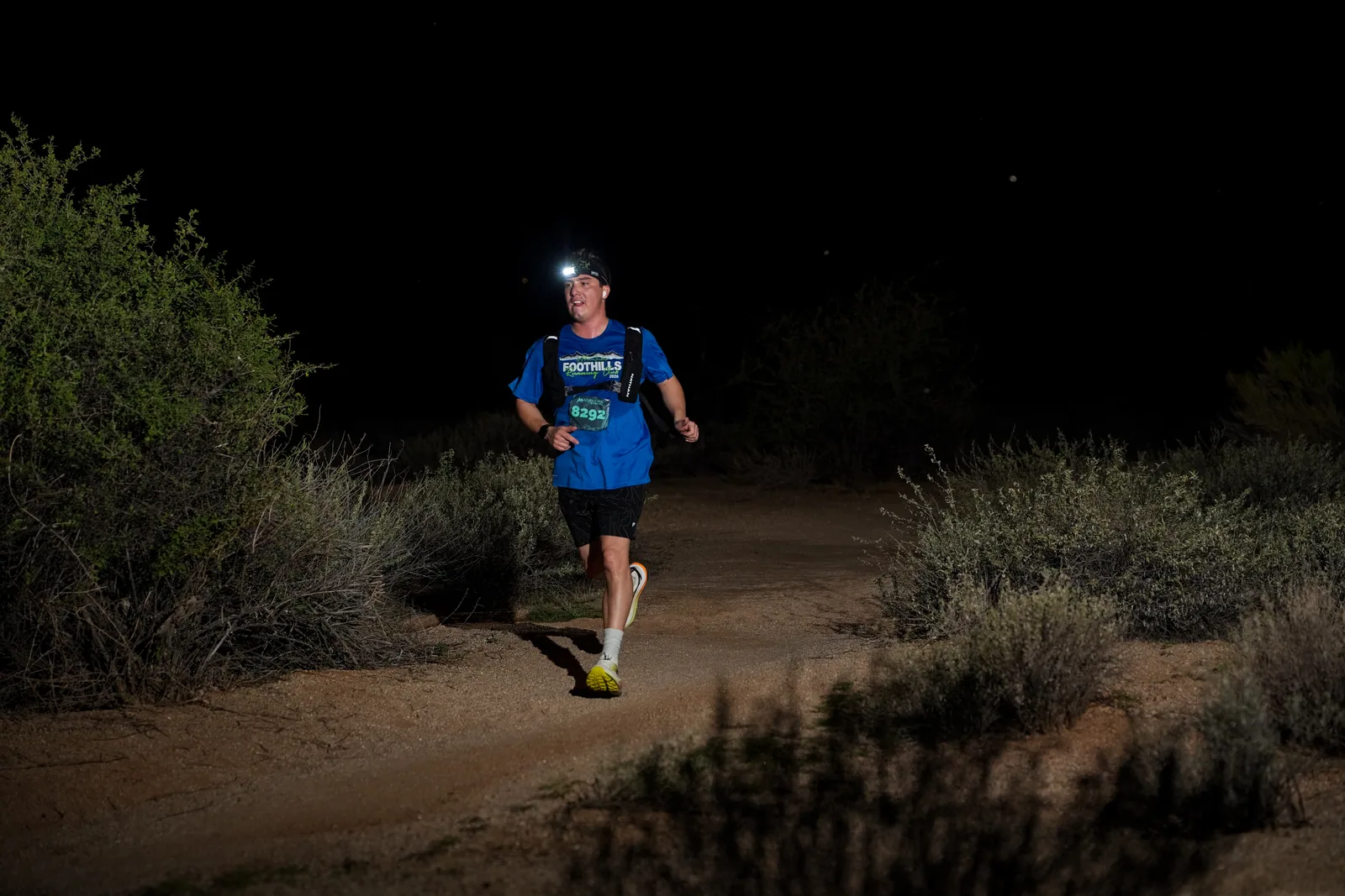 Runners at dusk and by headlamp at the Javelina Jangover Night Runs in McDowell Mountain Regional Park