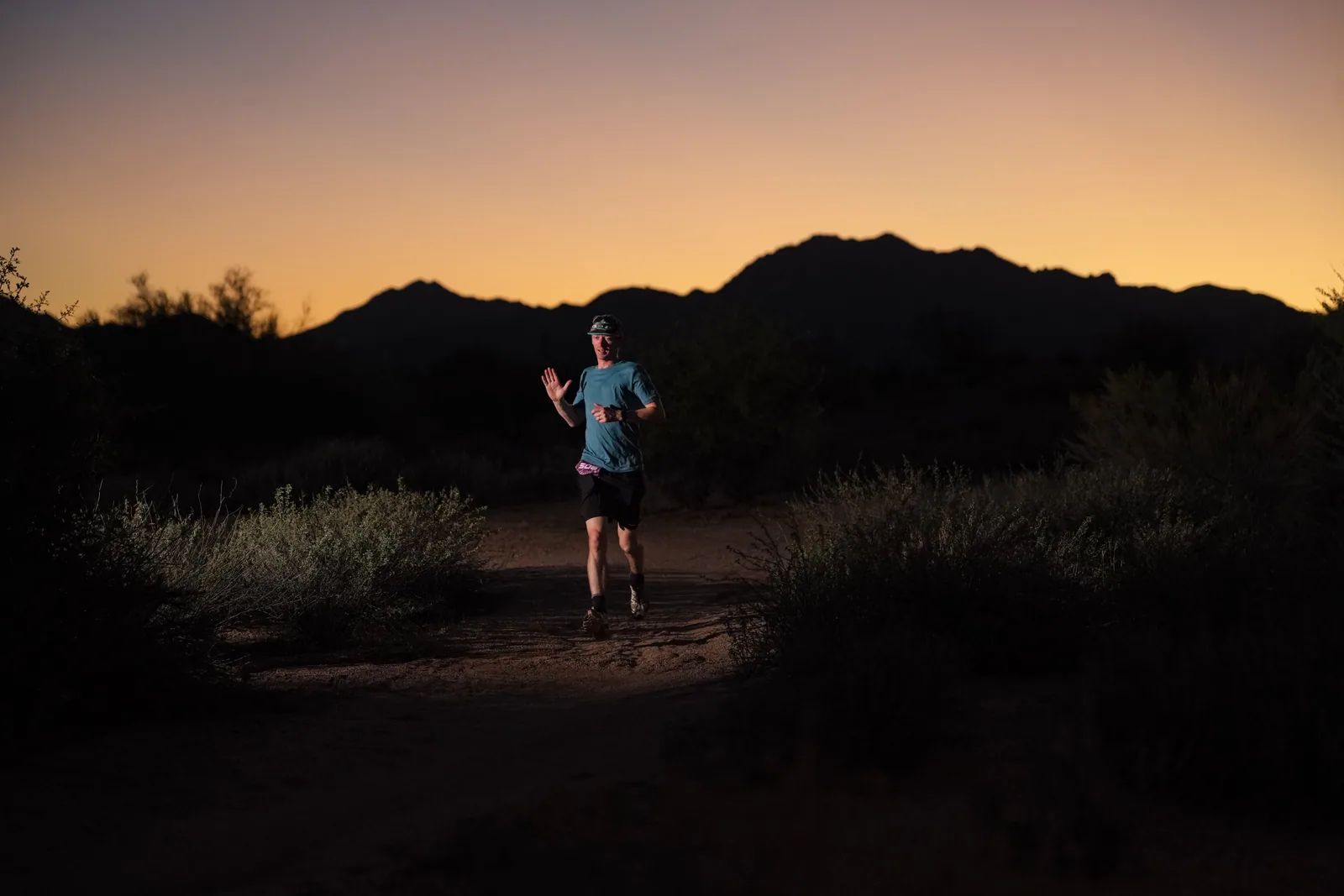 Runners at dusk and by headlamp at the Javelina Jangover Night Runs in McDowell Mountain Regional Park