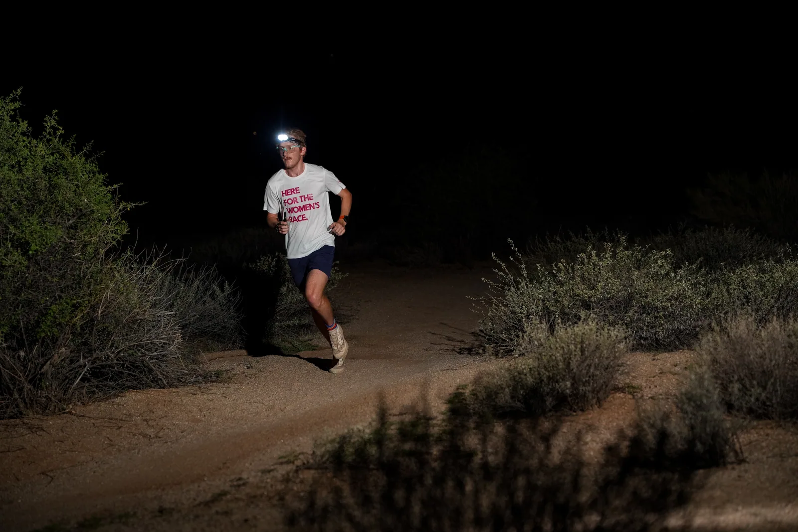 Runners at dusk and by headlamp at the Javelina Jangover Night Runs in McDowell Mountain Regional Park