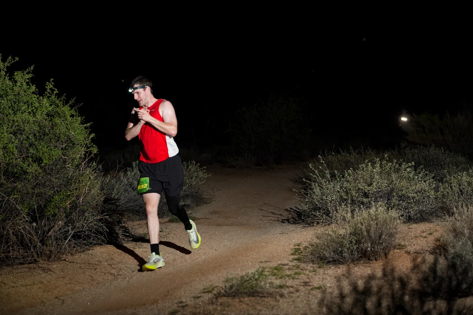 Runners at dusk and by headlamp at the Javelina Jangover Night Runs in McDowell Mountain Regional Park