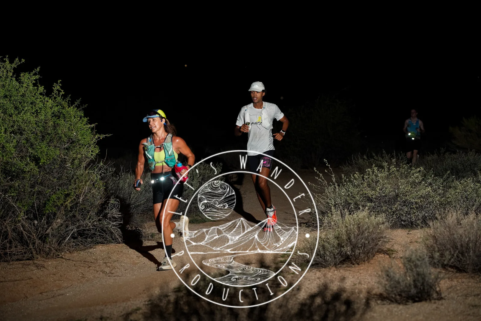 Runners at dusk and by headlamp at the Javelina Jangover Night Runs in McDowell Mountain Regional Park