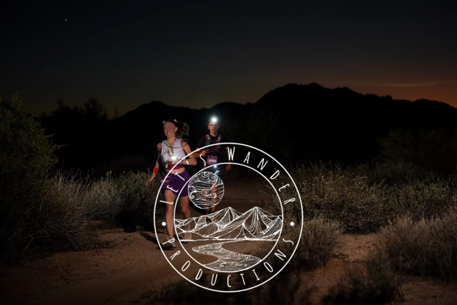 Runners at dusk and by headlamp at the Javelina Jangover Night Runs in McDowell Mountain Regional Park