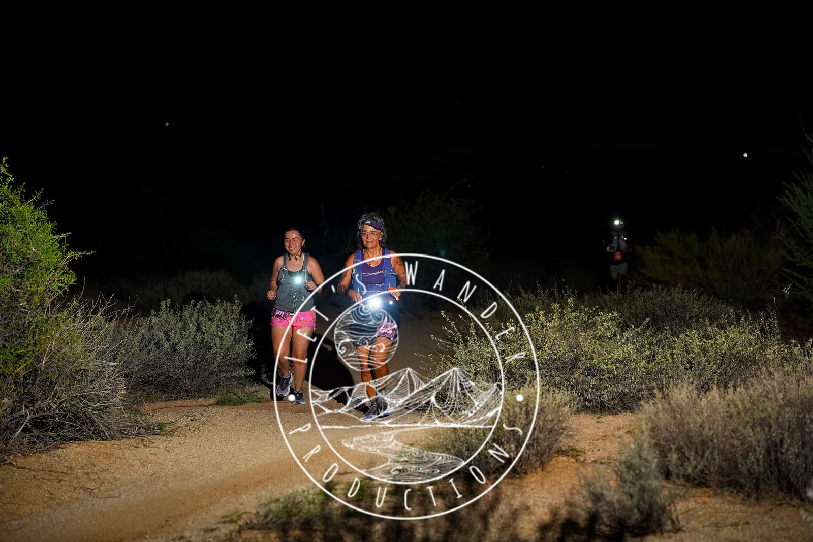 Runners at dusk and by headlamp at the Javelina Jangover Night Runs in McDowell Mountain Regional Park