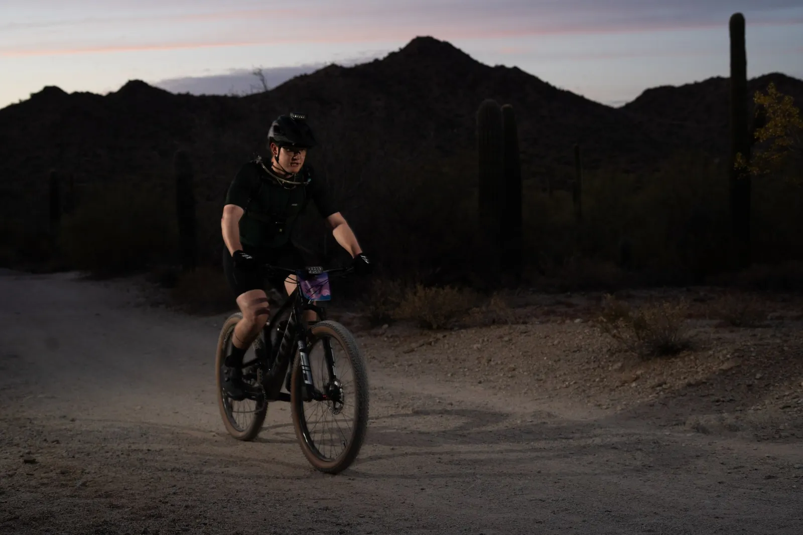 Rider at dusk below the San Tan Mountains at the Sinister Night Rides