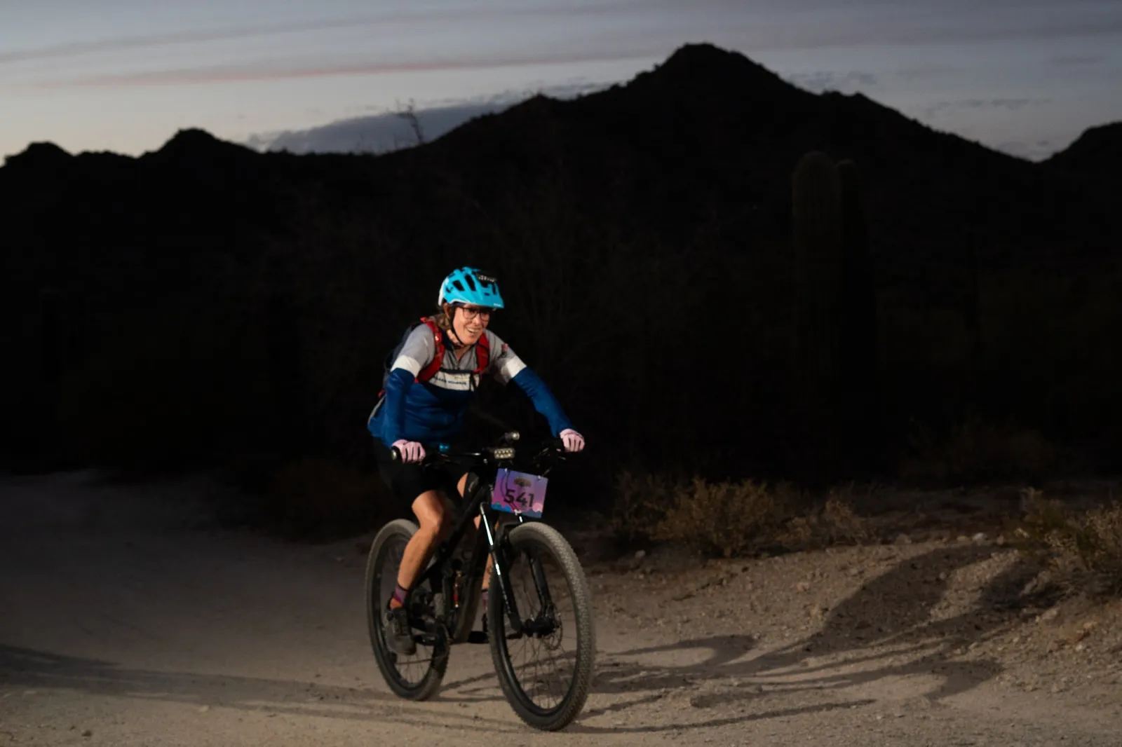 Rider at dusk below the San Tan Mountains at the Sinister Night Rides