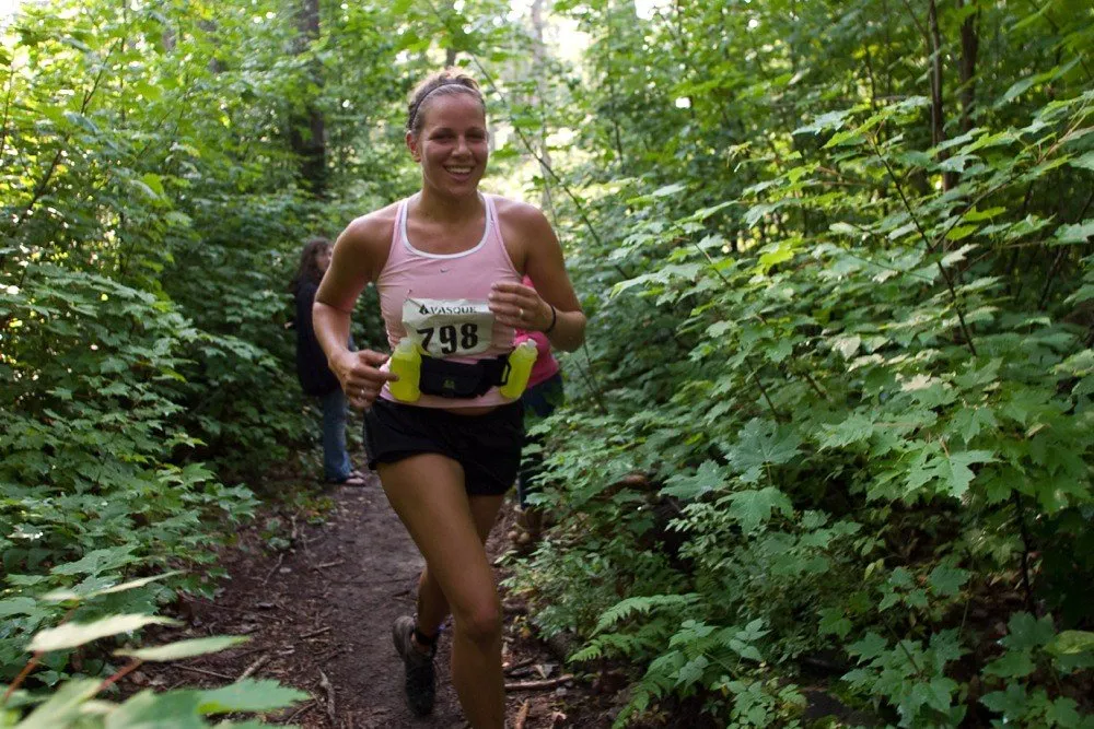A runner on singletrack through the forest