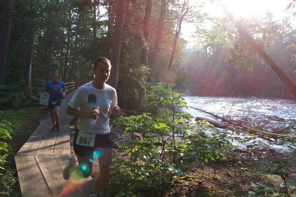 A runner on the boardwalk beside the river
