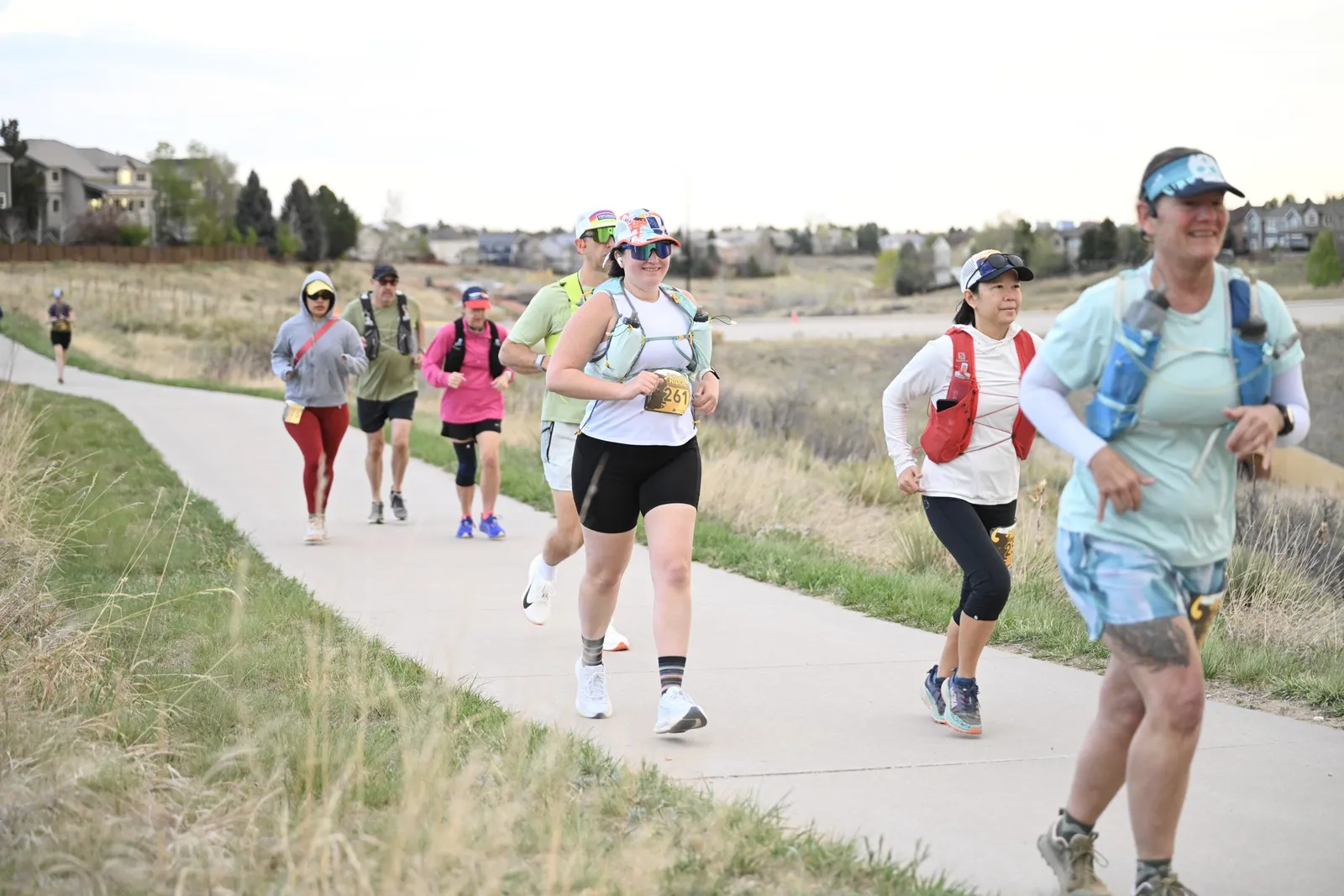 Runners smiling on the paved trail