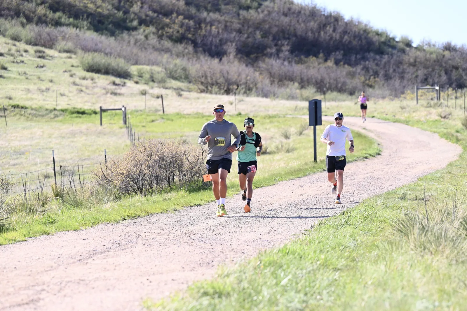 Runners rounding a bend on the dirt trail