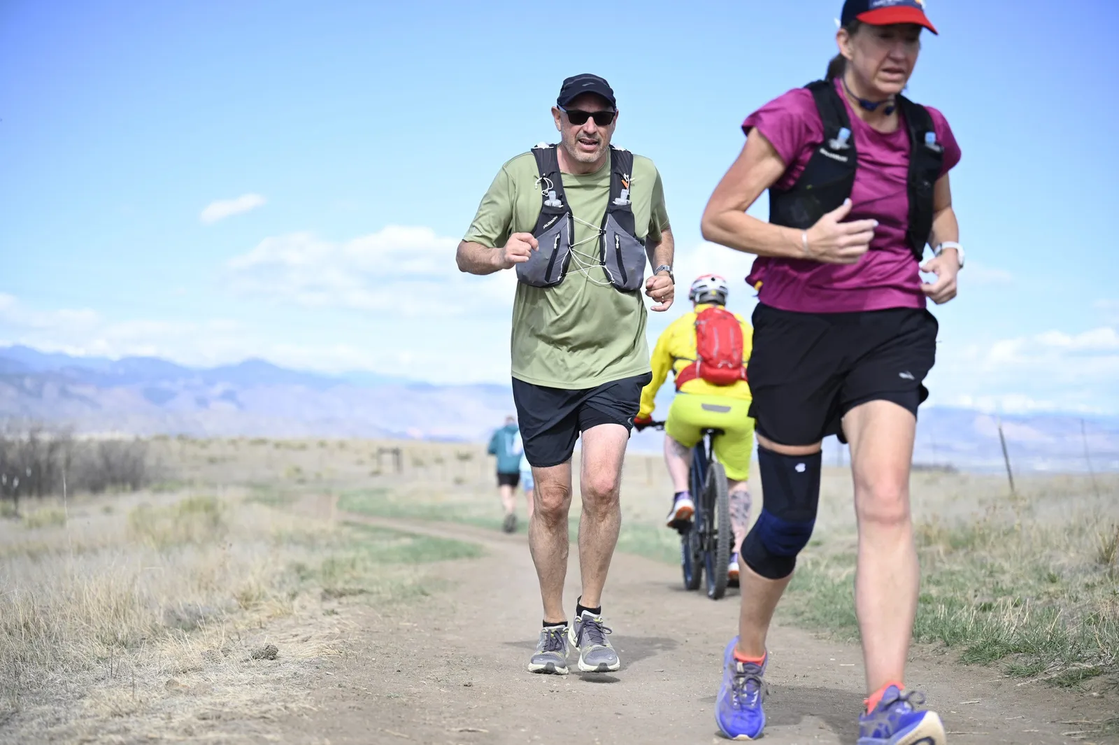 Two runners with the mountains behind them