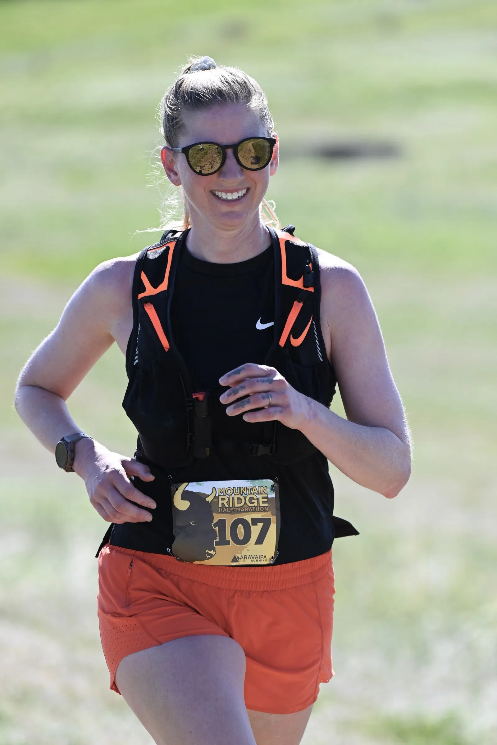 A runner smiling on the trail