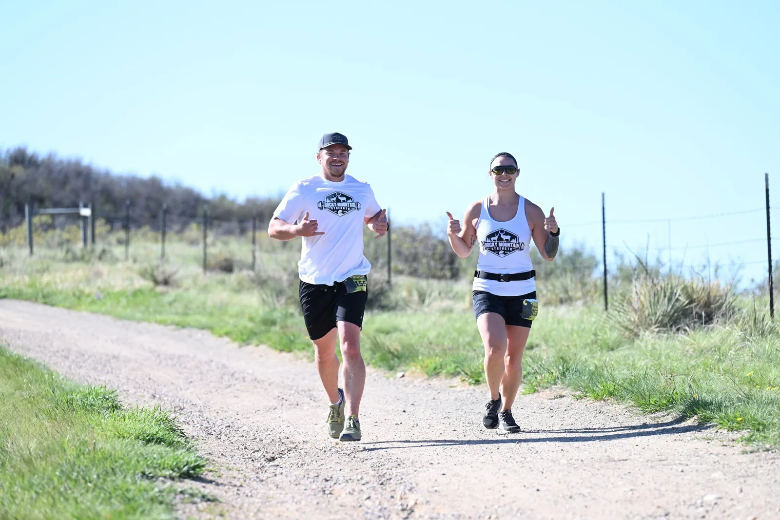 Two runners side by side on the trail