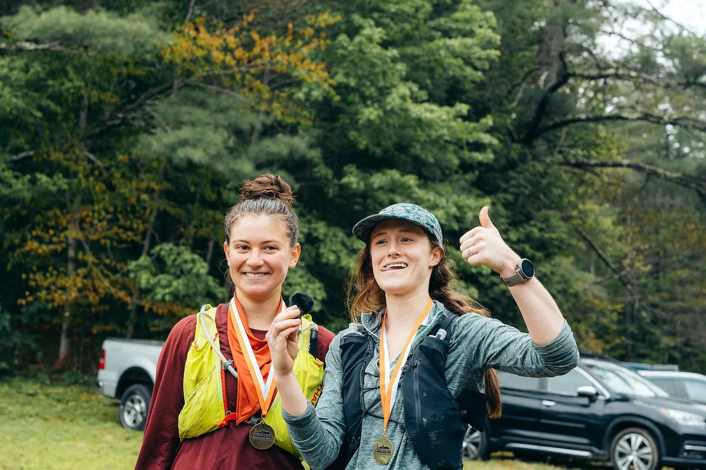 Two finishers showing off their medals