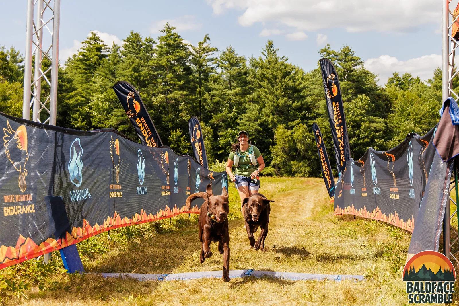 A runner and two dogs heading for the line