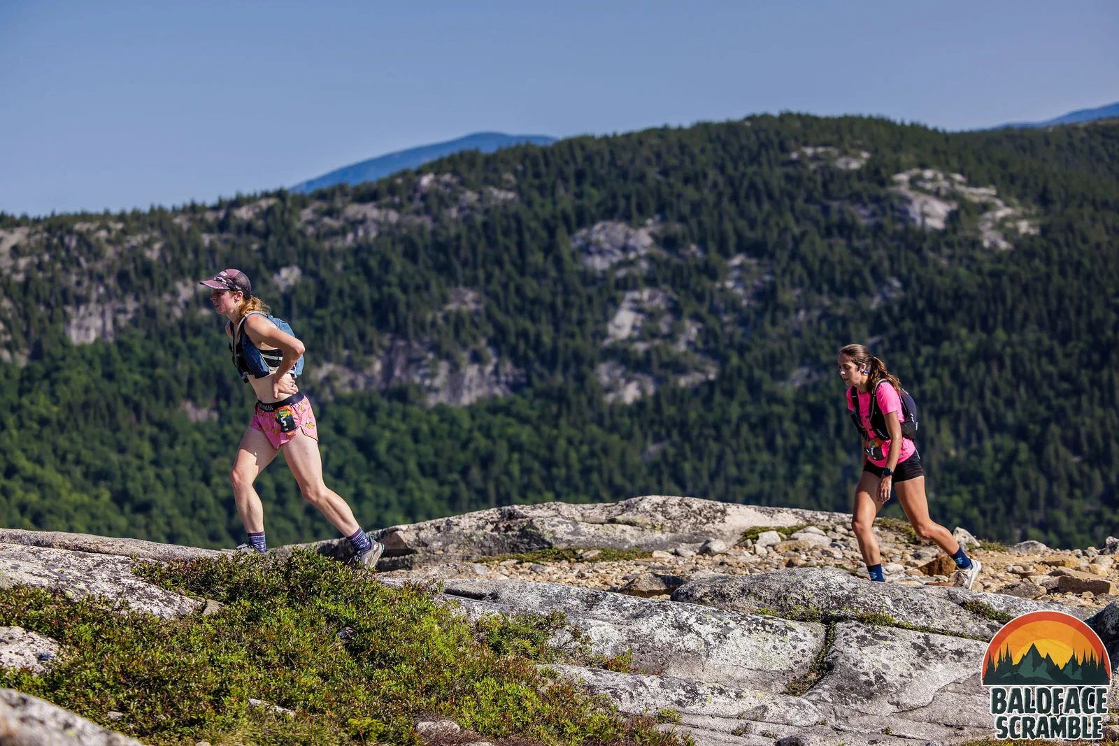 Two runners crossing the open ridge
