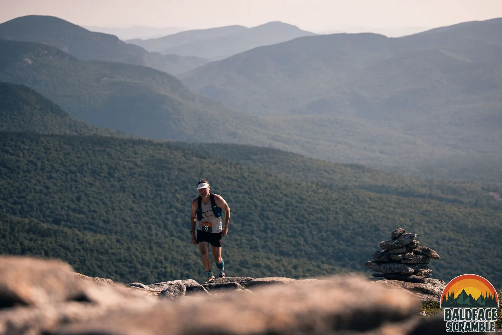 A runner and a cairn in the morning haze