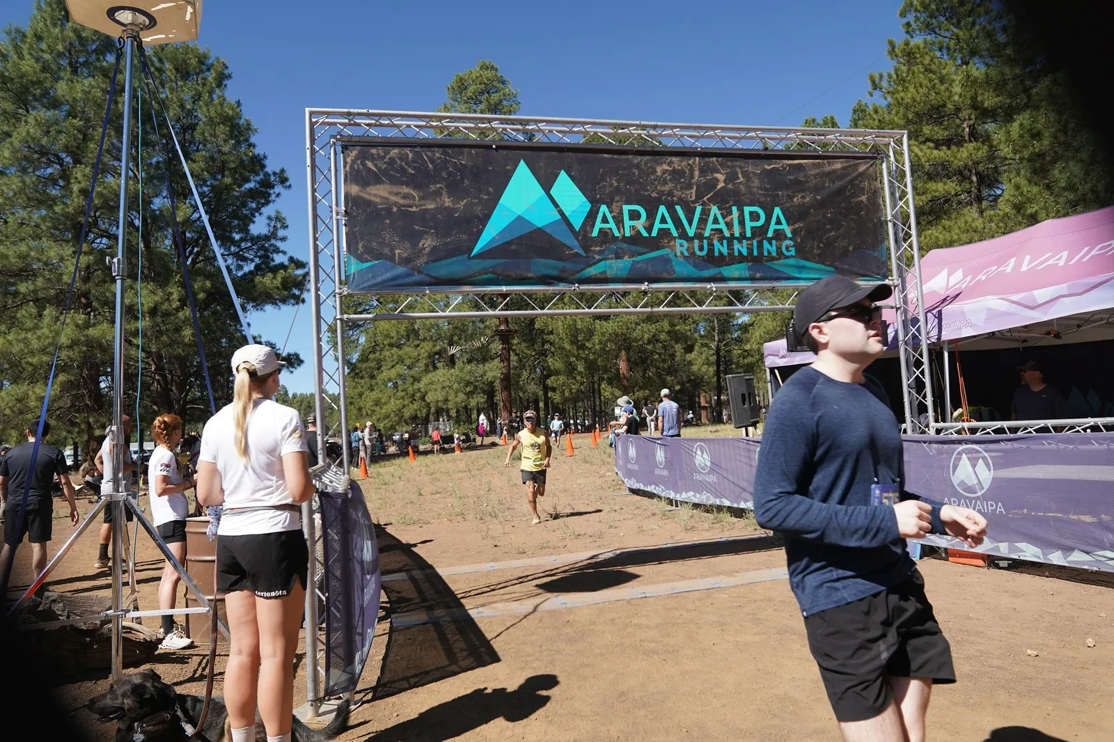 A runner arriving at the Big Pine Trail Runs finish line in the Flagstaff ponderosa pines