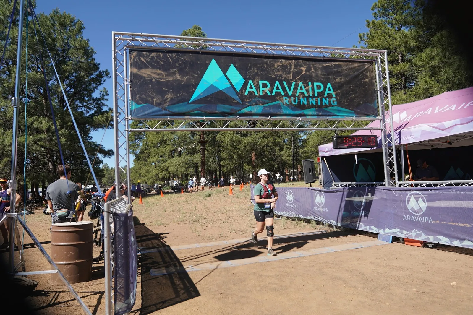 A runner in a cap at the Big Pine Trail Runs finish line in the Flagstaff ponderosa pines
