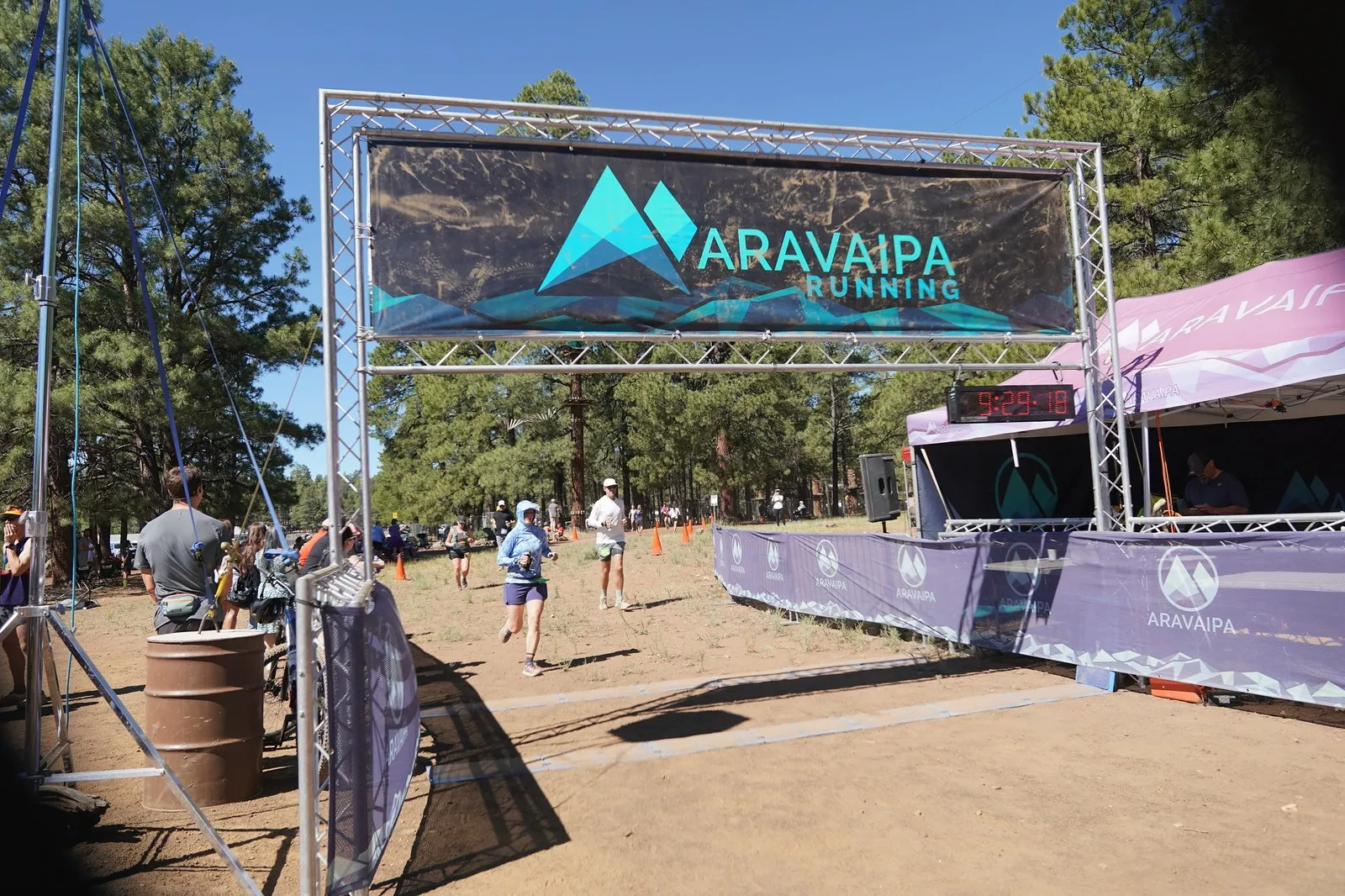 Two runners at the Big Pine Trail Runs finish line in the Flagstaff ponderosa pines