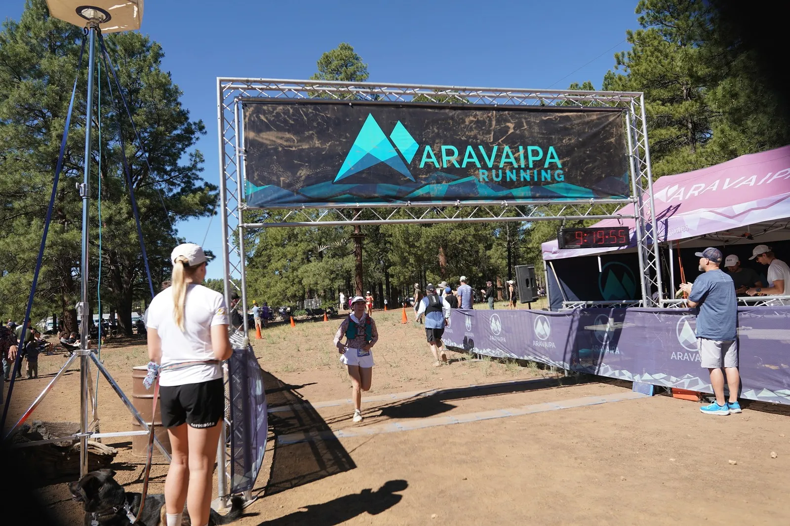 A runner coming in to the Big Pine Trail Runs finish line in the Flagstaff ponderosa pines