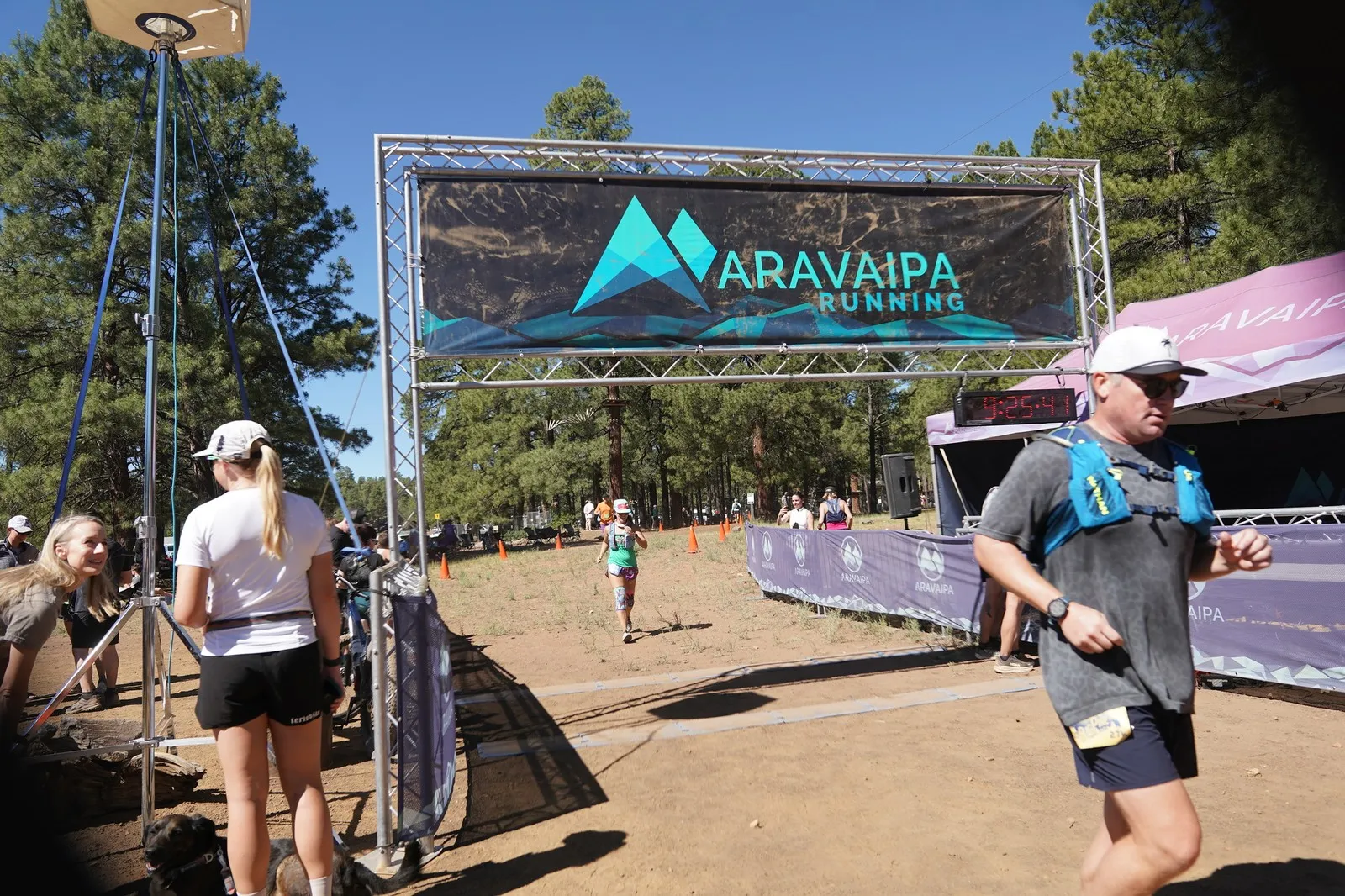 A runner in a vest at the Big Pine Trail Runs finish line in the Flagstaff ponderosa pines