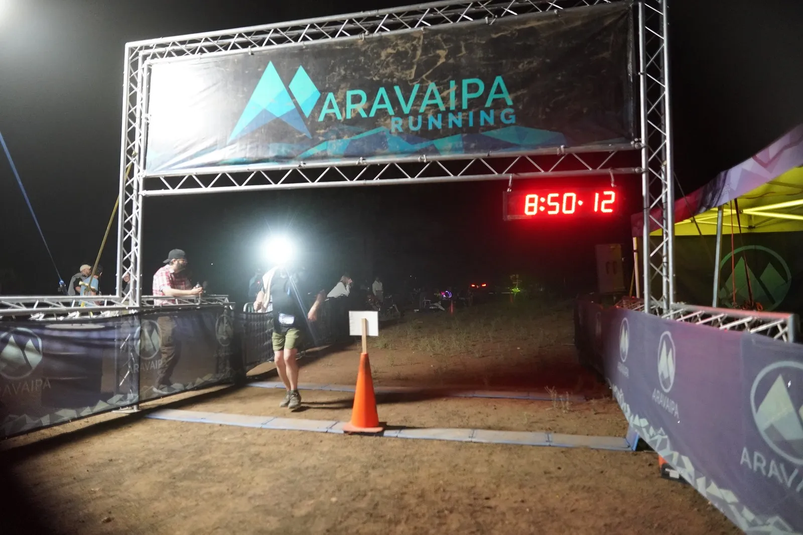 A bright headlamp at the Blackout Night Runs finish line in the Flagstaff pines