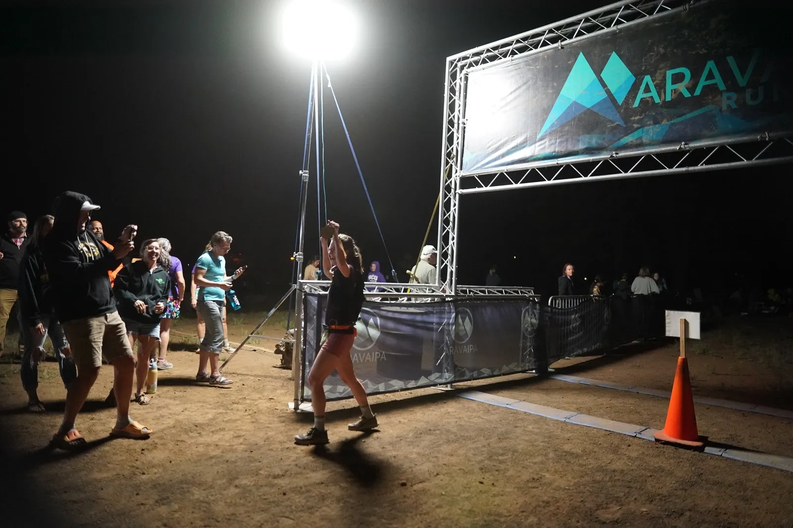 Cheering spectators at the Blackout Night Runs finish line in the Flagstaff pines